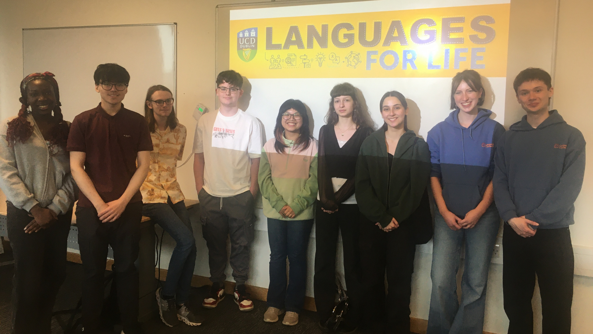 group of students in front of a whiteboard with the Languages for Life Logo on it